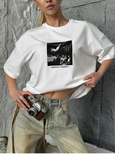 Detail of white cotton oversized T-shirt with vintage portrait print and slogan