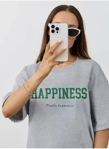 Close-up of HAPPINESS letter print on grey cotton t-shirt with loose drop shoulder