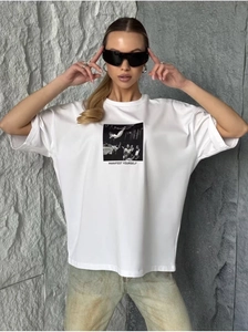Close-up of artistic photography print and MANIFEST YOURSELF text on white cotton T-shirt