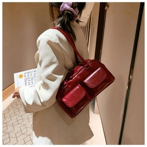 Detailed side view of vintage wine red leather shoulder bag with double pockets