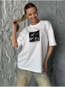 Detail of Manifest Yourself print on white loose cotton t-shirt with modern photography