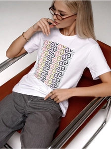 Detailed view of women's white cotton T-shirt with colorful geometric diamond pixel print