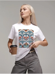 Detail of colorful ethnic print on premium white cotton t-shirt with crew neck design