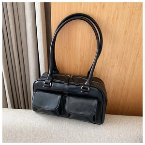 Detail of black matte leather handbag with dual magnetic pockets and two-way metal zippers