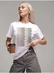 Detail of white cotton T-shirt featuring a colorful pixelated geometric diamond print