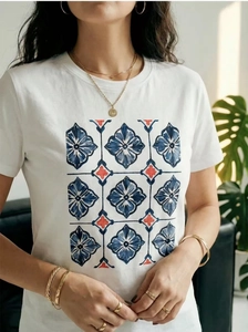 Close-up of a white cotton t-shirt with a blue and red geometric floral tile print
