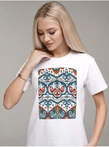 Detailed view of the ethnic geometric pattern print on a white cotton T-shirt for women