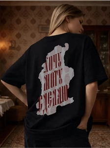 Detailed back view of a black cotton T-shirt featuring red Cyrillic text street art print