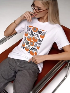 Close-up of white cotton T-shirt featuring artistic orange persimmon print and leaf detail