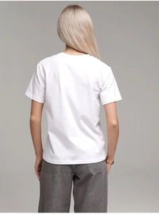 Rear view of white cotton crewneck t-shirt on model with grey studio background