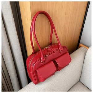 Detail of red PU leather small square bag featuring double front pockets and metal zipper
