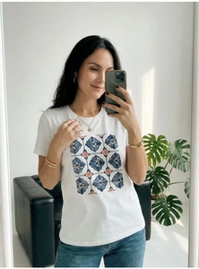 Detail of white cotton T-shirt featuring vintage blue and orange floral tile patterns