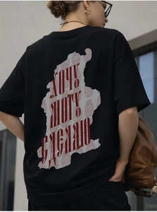 Detailed back view of black cotton T-shirt featuring bold red Cyrillic graphic print