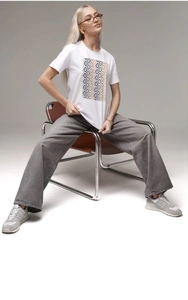 Detail shot of colorful geometric diamond pattern printed on a white cotton T-shirt