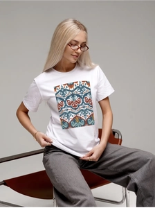 Close-up of white cotton T-shirt with a rectangular ethnic pattern on a female model