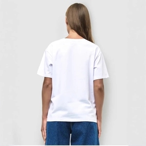 Back view of a white polka dot short sleeve T-shirt for women paired with blue jeans