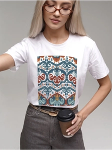 Detailed view of bohemian geometric print on a white cotton T-shirt worn by a model