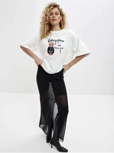 Detail of white cotton T-shirt featuring a red Matryoshka doll and graffiti print