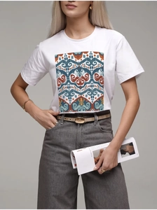 Close-up of vibrant ethnic geometric print on a white 100% cotton women's t-shirt