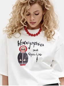 Detail of white cotton oversized T-shirt featuring a modern Matryoshka doll graphic print