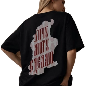 Oversized black cotton T-shirt featuring bold red Russian text print on the back