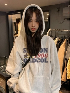 Detail of light grey oversized hoodie with Station 1996 graphic and kangaroo pocket