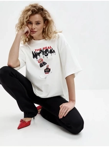 Dettaglio maglietta bianca oversize in cotone con stampa grafica matrioska skateboard