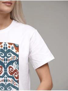 Detailed view of tribal graphic print on white 100% cotton T-shirt for women