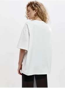 Detail view of white heavy cotton oversized t-shirt with loose drop shoulder fit