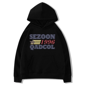Close-up of black oversized hoodie featuring vintage SEZOON 1996 graphic and ribbed cuffs
