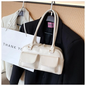 Off-white square tote bag in matte synthetic leather styled on a black blazer