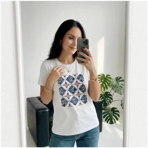 White cotton T-shirt with blue floral print paired with blue jeans in a modern home setting