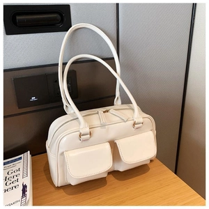 Detail view of cream white PU leather bag with front pockets and dual zipper closure