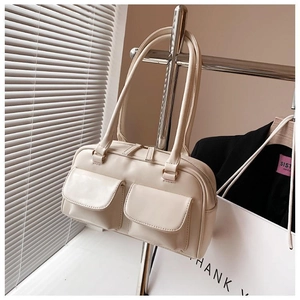 Detail of a chic cream-white PU shoulder bag with dual front flap pockets and zipper