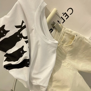 T-shirt chic blanc à manches courtes avec chat noir et pantalon crème assorti