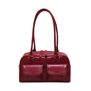 Dark red glossy leather handbag with dual front pockets and shoulder straps for women