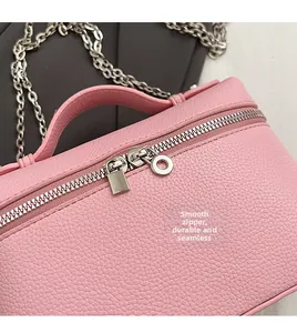 Close-up of pink lychee grain leather handbag with smooth dual silver zippers