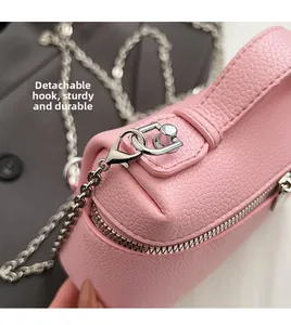 Detailed close-up of pink litchi leather bag with durable silver metal chain and detachable hook