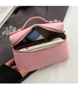 Pink lychee grain leather bag interior with silver chain and herringbone fabric lining