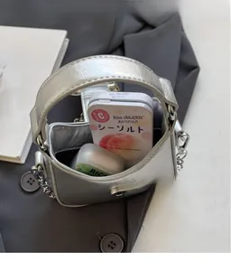 Internal view of silver pleated mini crossbody bag showing storage space for small items