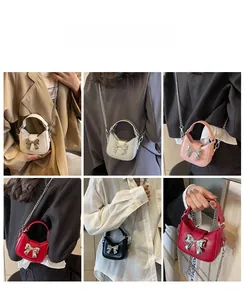 Six different colors of bow mini crossbody bags with metallic chains shown on models