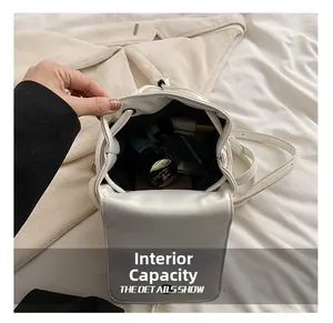 Detail view of white drawstring backpack showing spacious interior for cosmetics