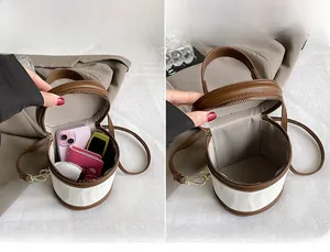 Interior view of the round bucket bag showing capacity for phone and wallet essentials