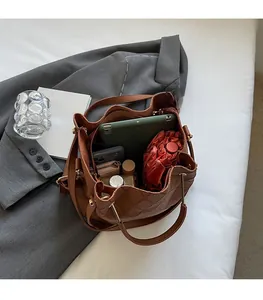 Top view of brown quilted bucket bag interior showing spacious room for tablet and essentials