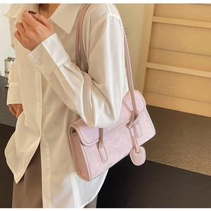 Detail of light purple underarm bag with marble texture and heart charm on model