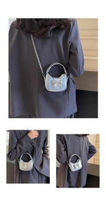 Silver metallic mini crossbody bag with bow detail and chain strap worn on back