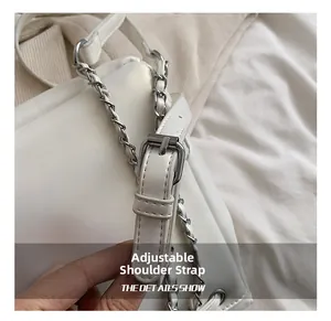 Detail of adjustable leather and chain woven shoulder strap with metal buckle for backpack
