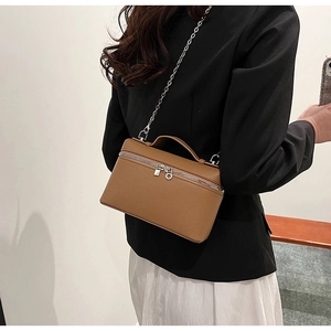 Caramel lychee grain leather crossbody bag with silver zipper and chain strap detail