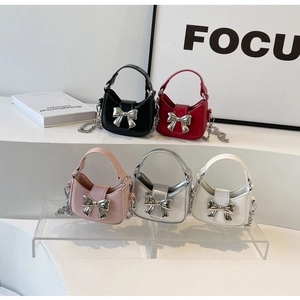 Collection of mini bow handbags in black, red, white, pink and silver finishes