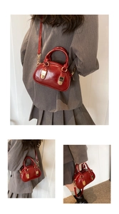 Three-way view of a vintage wine red leather mini bowling bag with gold hardware detail
